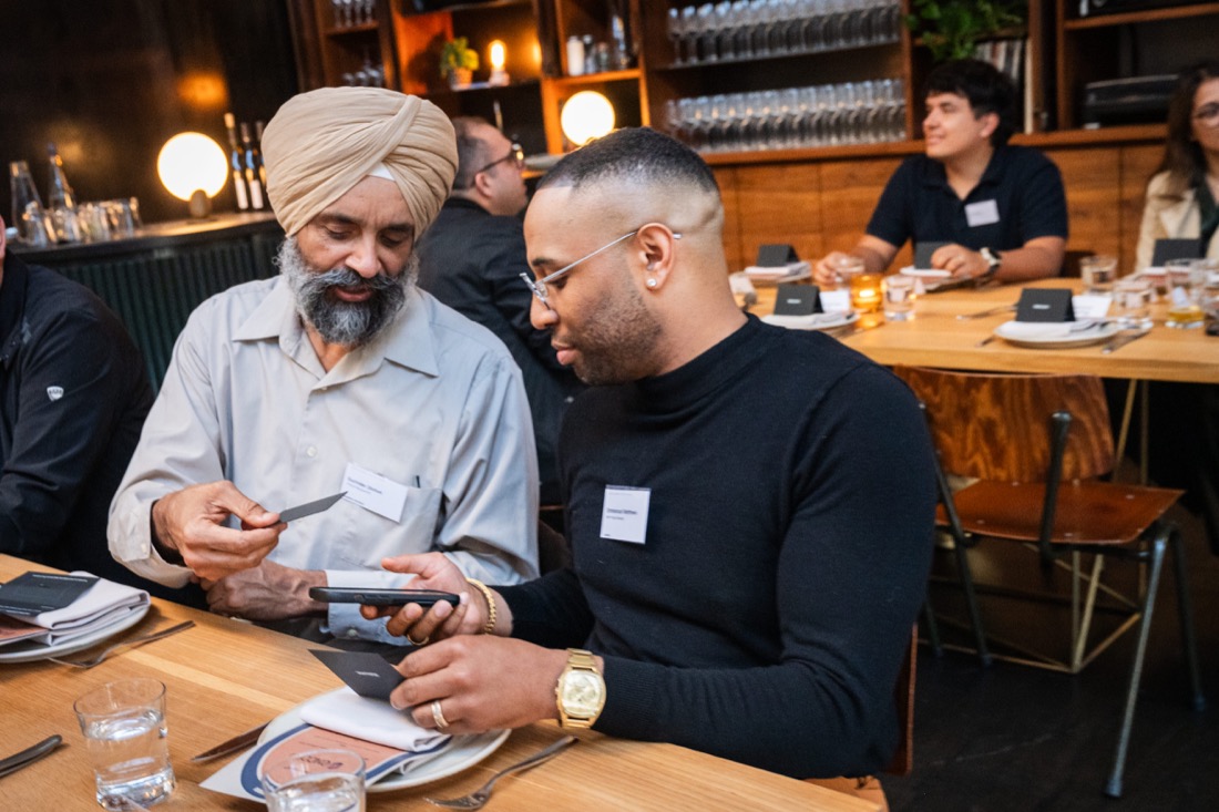 Guests using a Tap & Connect card with a phone at a Global Leaders dinner